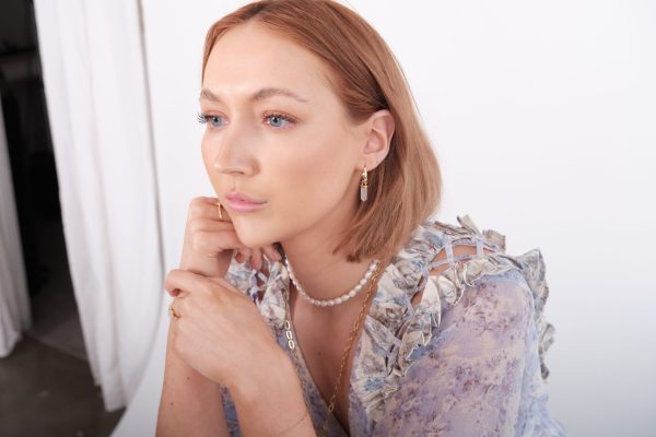 model wearing white quartz crystal hoop earrings