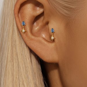 blue stargazer earrings on model