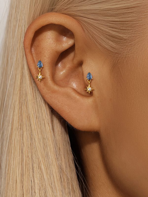 blue stargazer earrings on model